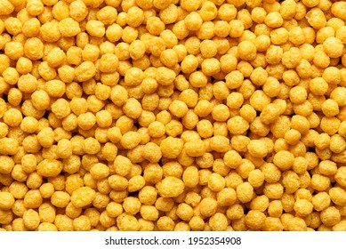 Honey Pops Breakfast Cereals Background, Flat Lay. Full Frame With Cornflakes. Delicious Corn Cereal Balls. Macro Image With Yellow Round Cereals.