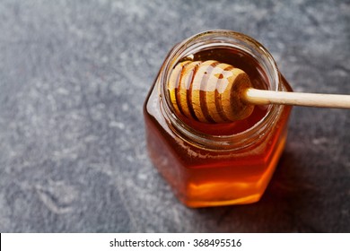 Honey In A Pot Or Jar On Kitchen Table, Top View