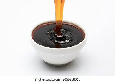 Honey pouring into white small  bowl - Powered by Shutterstock