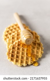 Honey Pouring On A Fresh Waffles Breakfast With Belgian Waffles Gray Background Vertical