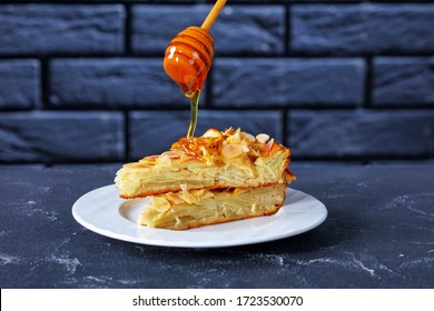 Honey Is Pouring On A Top Of A Stack Of Slices Of Invisible Apple Cake, Gateau Invisible On A Plate, French Cuisine, Horizontal View From Above, Close-up