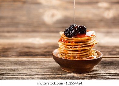 Honey Pouring Over A Stack Of Mini Pancakes