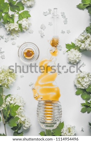 Similar – Image, Stock Photo Honey flows from glass and flowers