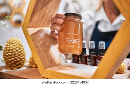 Honey, product and retail with hands of woman and display shelf for grocery, natural and health food. Wellness, trader and organic with small business owner for sustainability, supermarket and store - Powered by Shutterstock