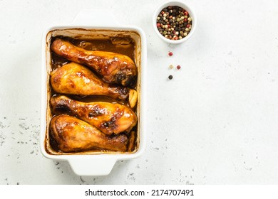 Honey soy chicken drumsticks in baking dish.Top view, copy space.