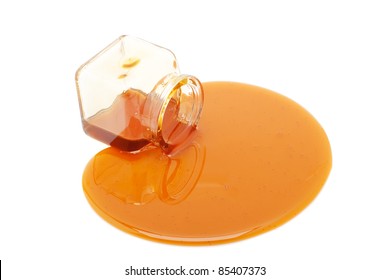 Honey Spill From A Glass Jar Isolated On White