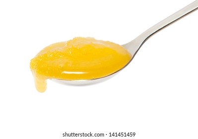 Honey In A Spoon Isolated On White Background