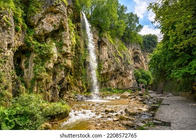 Honey Waterfalls in Kislovodsk, Russia. Water falls into gorge, mountain landscape with rocks, nice canyon and trees in summer. Theme of nature, travel, hike and forest in Caucasus Mineral Waters. - Powered by Shutterstock