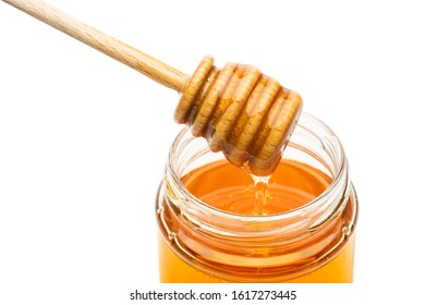 Honey Wooden Dripper Closeup Above Glass Jar, On White Background