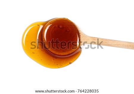 Honey and wooden spoon isolated on white background