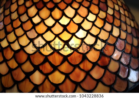 Honey, yellow, scale-shaped Tiffany-like design colorful glass lamp shade detail