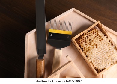 Honeycomb Frames And Beekeeping Tools On Wooden Table, Top View