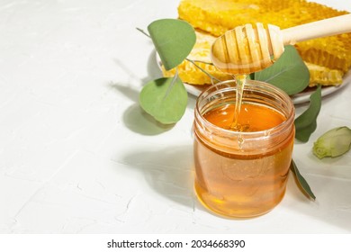 Honeycomb, Honey, And Beeswax. Natural Organic Beekeeping Products For A Healthy And Beautiful Lifestyle. Hard Light, Dark Shadow, White Plaster Background, Copy Space