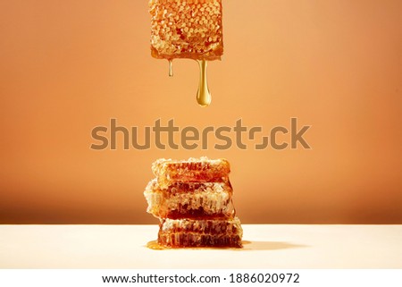 honeycomb and honey on yellow background