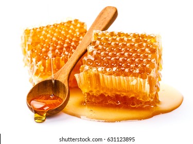Honeycomb with honey spoon isolated on white background, bee products by organic natural ingredients concept