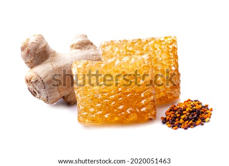 Honeycomb with pollen and ginger root isolated on white backgrounds.Healthy food ingredient. 
