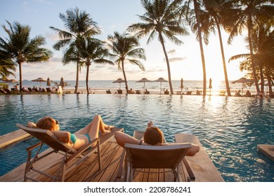 honeymoon couple relaxing in beach hotel near swimming pool at sunset, dream holidays - Shutterstock ID 2208786241