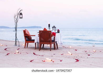 Honeymoon dinner table on island beach with candle at evening in Thailand - Shutterstock ID 1973927357