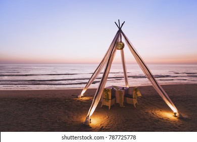 Honeymoon Dinner For Wedding Couple On The Beach In Luxurious Romantic Hotel, Beautiful Table For Two At Sunset