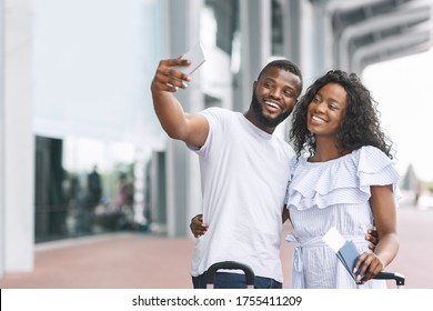 Honeymoon Memories. Happy Romantic Black Couple Taking Selfie Near Airport Terminal, Ready For Travel, Copy Space