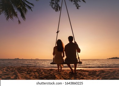 honeymoon travel, silhouette of romantic couple on sunset  beach, tropical holidays near the sea, man and woman together on vacation - Powered by Shutterstock