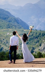 honeymoon wedding couple travel mountains back view. Mountains and sea background in Montenegro. Fine art style