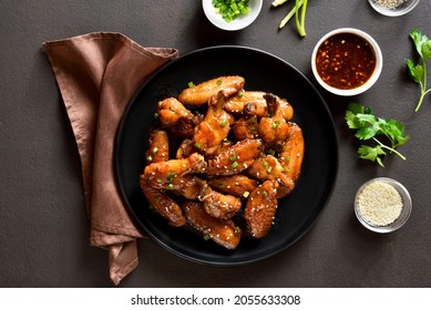 Honey-soy Chicken Wings On Plate Over Dark Stone Background. Top View, Flat Lay, Close Up