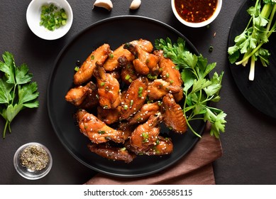 Honey-soy Chicken Wings On Plate Over Dark Stone Background. Top View, Flat Lay, Close Up