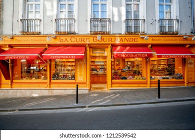 HONFLEUR, FRANCE - September 06, 2017: Street view with beautiful yellow sweet food store front in Honfleur old town, normandy region in France
