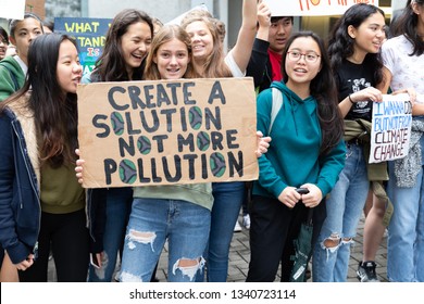 Hong Kong, 15th March 2019 Climate Change School Strike March In Hong Kong. A Group Of Teenagers Hold A Placard Asking For Solutions To Pollution Outside Hong Kong Government Offices.