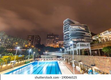 HONG KONG - APR 30, 2014: Night View Of The Jockey Club Innovation Tower. It Is Home To Hong Kong Polytechnic University's School Of Design. Designed By Pritzker-prize-winning Architect Zaha Hadid 