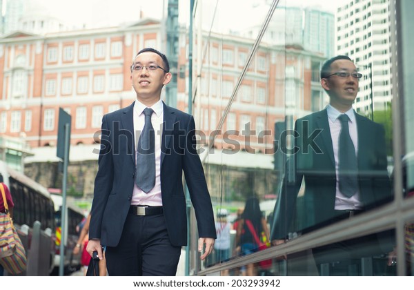hong\
kong businessman in busy central district\
street