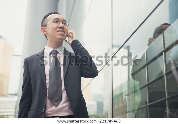 hong kong businessman in busy central district,\
light vintage blue tone\
applied