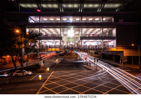 Hong Kong, China - 15/01/2019: A long exposure\
night photo of an Apple store in Hong Kong Island. Even though it\'s\
night time, customers are still looking at iPhones and iPads inside\
the shop.