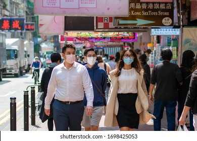 Hong Kong /China - Apr 9 2020: Mask-wearing Pedestrians On The Pavement