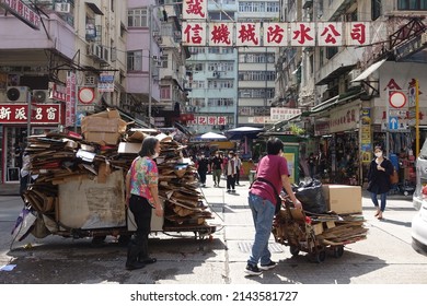 Hong Kong, China - April 06, 2022: City Street View of Mong Kok. The People must Wear Mask in the street, because of COVID-19.