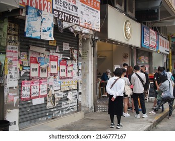 Hong Kong, China - April 17, 2022: City Street View of Yuen Long in Hong Kong. Some shop are closed. The People must Wear Mask because of COVID-19.