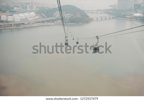 Hong Kong/\
China - April, 21, 2018: Cable Car at Ngong Ping at city view ,\
Hong Kong. The Ngong Ping cable cars is the popular public\
transportation from Tung Chung to Ngong\
Ping.