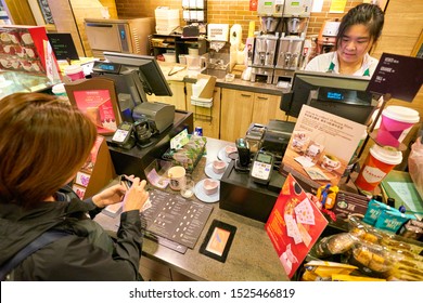 HONG KONG, CHINA - CIRCA JANUARY, 2019: Staff Taking An Order From Woman At Starbucks Coffee In Hong Kong.