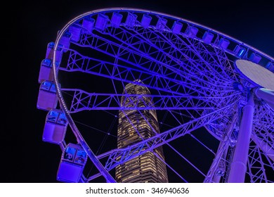 HONG KONG, CHINA - DECEMBER 4, 2015: Ferris wheel and skyscraper