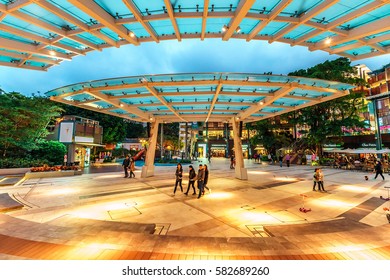 Hong Kong, China - January 30, 2016: Stanley Plaza On Hong Kong Island In Hong Kong City In The Evening With Street Illumination. People Walk Along Children Playground At The Spacious Amphitheater