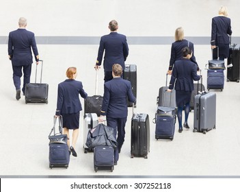 Hong Kong, China - June 12, 2015: Group Of Cabin Crew Walking At The Hong Kong International Airport, Carrying Their Luggage