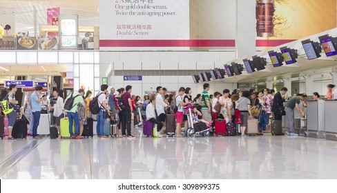 Hong Kong, China - June 23, 2015: Passengers queuing up in check-in counter in the Hong Kong International Airport.