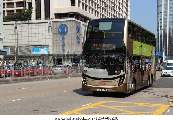 Hong Kong, China - October 4, 2018: Hong Kong\
double-decker bus. Bus follows the route on a city street in Hong\
Kong. Movement and city life in this Asian international business\
and financial center.