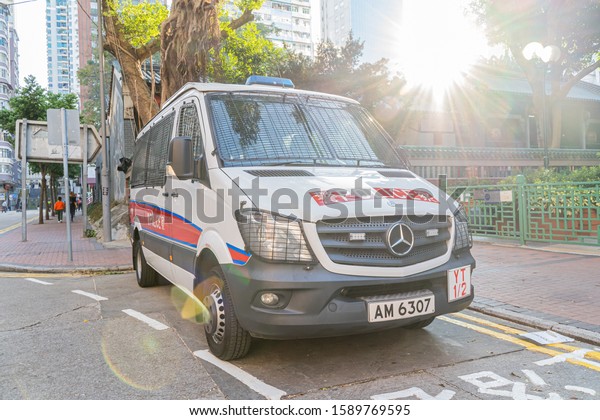 HONG KONG, CHINA - Hong Kong police vehicle on duty\
on Nathan Road in Kowloon, Hong Kong, China. The Mercedes-Benz\
Sprinter van is the most commonly seen police vehicles in Hong\
Kong.November28, 2019.