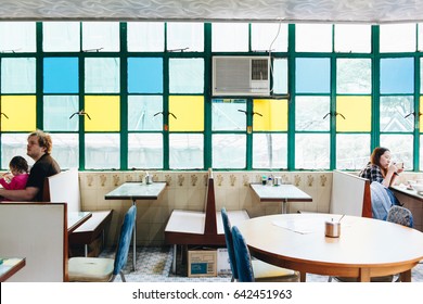 HONG KONG - CIRCA APRIL, 2017: People Are Eating Their Meal In Retro Cafe In Mong Kok. Mong Kok Is The Area That Mixed Of Vintage Old Town And New Shopping Shop With Colorful Neon Sign.