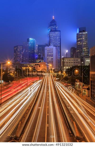 Hong kong city Car light trails\
and urban landscape night traffic modern buiding in Hong\
Kong\
