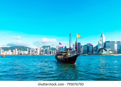 Hong Kong cityscape and skyline, Tourist junk boat at Victoria Harbor, Beautiful view of the Hong Kong Island.