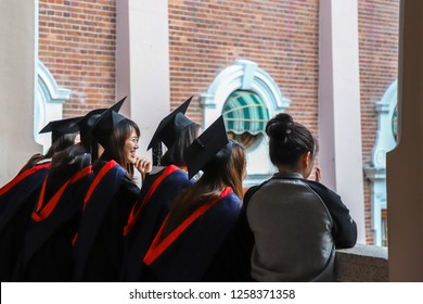 Hong Kong, December 15, 2018: Happy Freshly Graduated Undergraduate And Research Students And Families And Friends Are Taking Photos In The Campus (main Building) Of University Of Hong Kong (HKU)