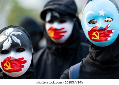 HONG KONG - DECEMBER 22 2019: A Group Of Protestors Wear Masks Symbolizing The Communist Party Of China's Silencing Of Uyghur Muslims And The Hong Kong Pro-democracy Movement At A Rally In Hong Kong.